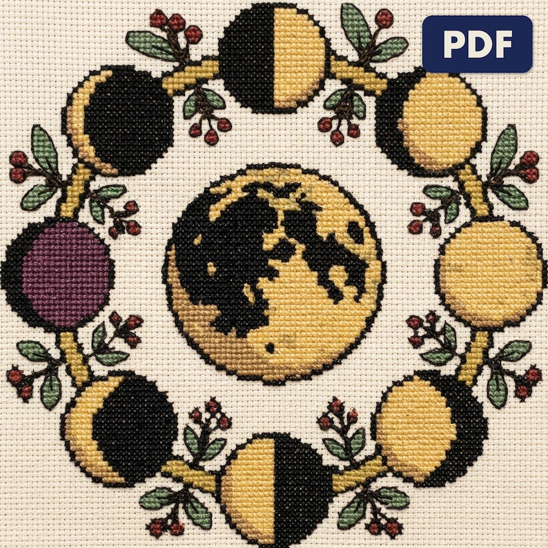 A finished a moon phase wheel cross stitch piece, stitched and framed on a wall