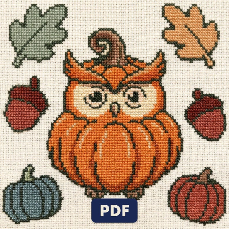 A finished owl cross stitch piece, stitched and framed on a wall