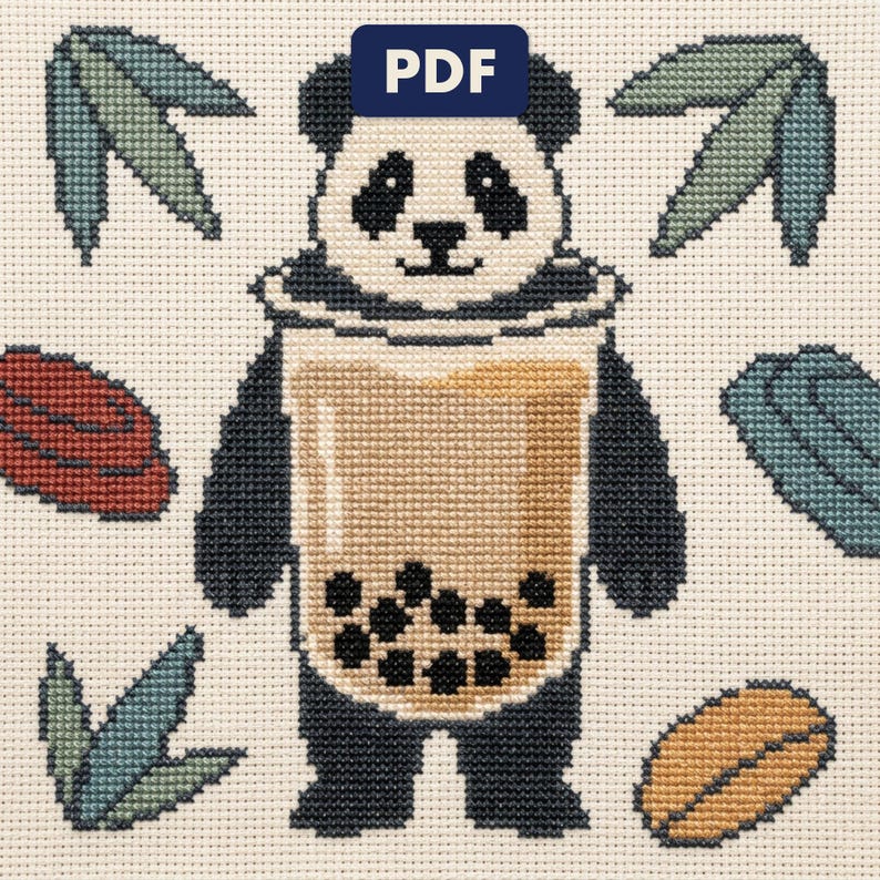 A finished panda cross stitch piece, stitched and framed on a wall
