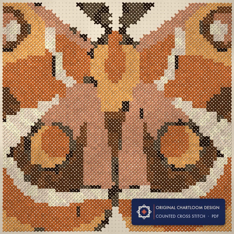 Close up of the a vintage moth cross stitch design worked stitch by stitch, every cross and thread colour visible