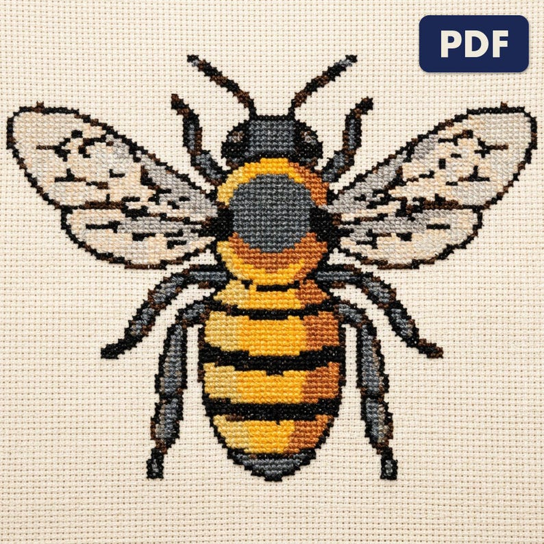 A finished a honeybee cross stitch piece, stitched and framed on a wall