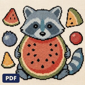 A finished raccoon cross stitch piece, stitched and framed on a wall