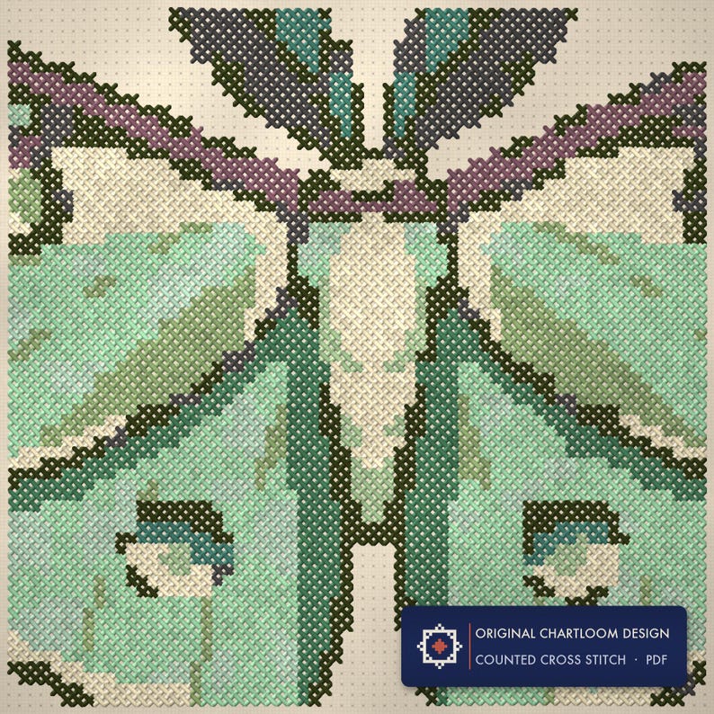 Close up of the a luna moth cross stitch design worked stitch by stitch, every cross and thread colour visible