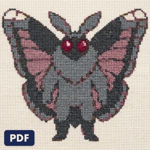 A finished mothman cross stitch piece, stitched and framed on a wall