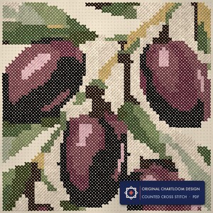 Close up of the an olive branch cross stitch design worked stitch by stitch, every cross and thread colour visible