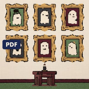 A finished a gallery of ghost portraits cross stitch piece, stitched and framed on a wall