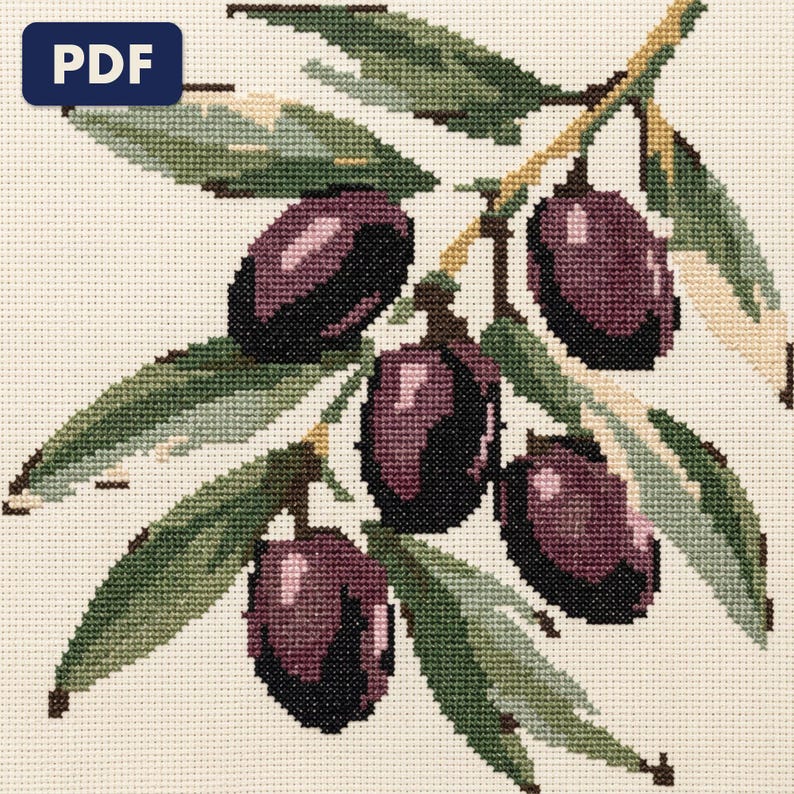 A finished an olive branch cross stitch piece, stitched and framed on a wall