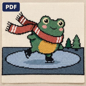 A finished a frog ice skating cross stitch piece, stitched and framed on a wall