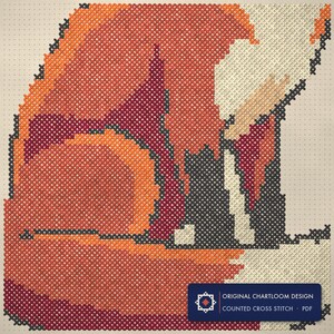 Close up of the a red fox cross stitch design worked stitch by stitch, every cross and thread colour visible
