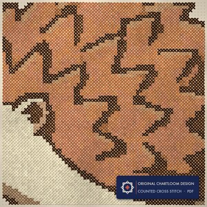 Close up of the a hedgehog cross stitch design worked stitch by stitch, every cross and thread colour visible