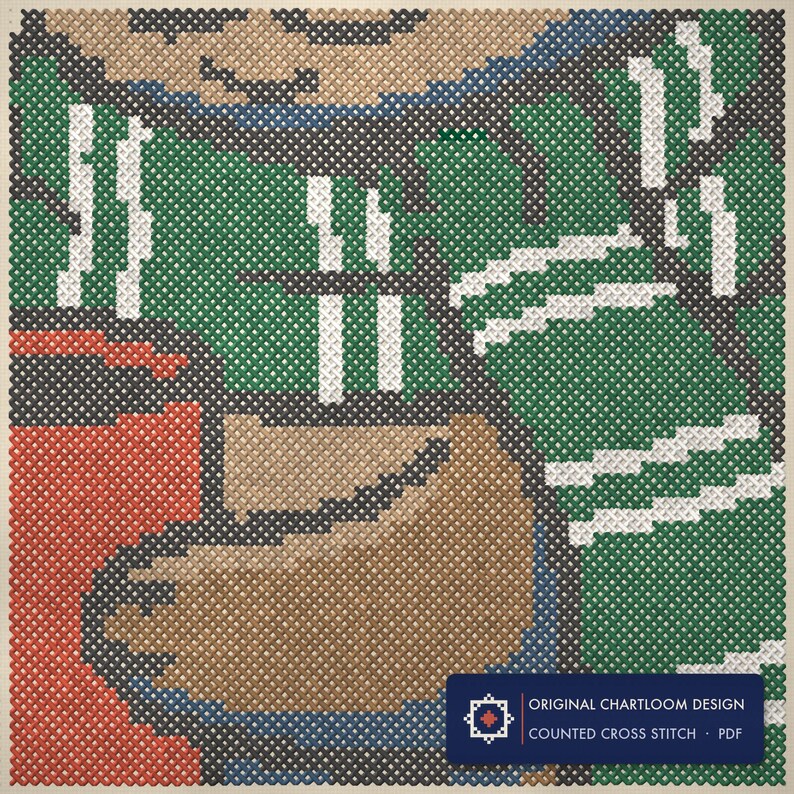 Close up of the an otter with a mug of cocoa cross stitch design worked stitch by stitch, every cross and thread colour visible