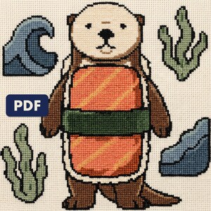 A finished otter cross stitch piece, stitched and framed on a wall