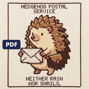 A finished hedgehog postal service cross stitch piece, stitched and framed on a wall