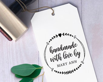 May include: A wooden stamp with a black handle. The stamp reads "handmade with love by MARY ANN" in a circle with a heart and floral accents.