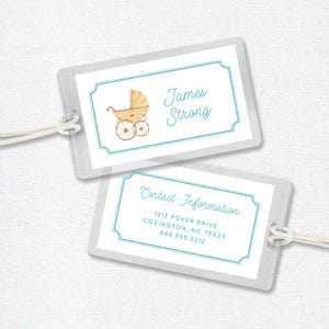 May include: Two luggage tags with a blue border. The top tag has a watercolor illustration of a baby carriage and the text "James Strong". The bottom tag has the text "Contact Information" and the address "1213 Power Drive, Covington, NC 75023, 888.555.5212".