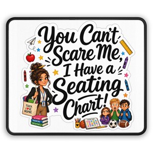 May include: A rectangular mouse pad featuring the text You Can't Scare Me, I Have a Seating Chart! with an illustration of a teacher holding a tote bag that says TEACH LOVE INSPIRE, a stack of books, three students, a soccer ball, and a football.
