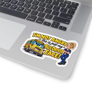 May include: A die-cut sticker featuring a yellow school bus with an angry face and a bus driver with blonde hair in a ponytail, arms crossed, wearing a blue uniform. The text reads, I'M NOT ANGRY this is just my BUS DRIVER FACE!