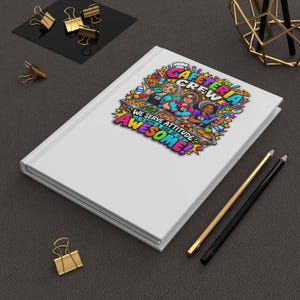 May include: A white notebook featuring a colorful graphic of three cafeteria workers behind a food counter. The text reads CAFETERIA CREW WE SERVE ATTITUDE WITH A SIDE OF AWESOME. The design includes food items, hearts, and stars in vibrant colors.
