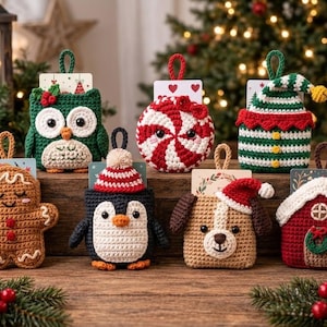 May include: A collection of seven crocheted gift card holders featuring holiday themes including a gingerbread person, an owl, a peppermint swirl, an elf hat, a penguin, a puppy, and a small house, each with a hanging loop.