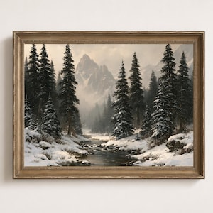 May include: A framed landscape painting depicting a winter scene with a flowing stream, snow-covered ground, and tall evergreen trees. In the background, jagged, snow-capped mountains rise into a soft, overcast sky, all enclosed in a gold frame.