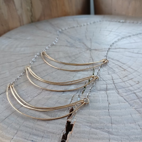 Necklace... "Sunlight" hammered brass wire suspended on a sterling silver chain.