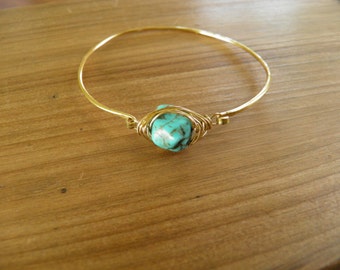 Bracelet... Bangle Bracelet hammered brass with a wire wrapped turquoise stone.