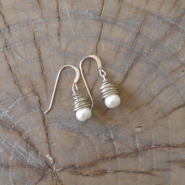 Earrings "Spun" pearl earrings wire wrapped with sterling silver.