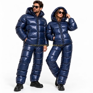 May include: A matching set of navy blue, high-gloss, quilted puffer jackets with hoods and coordinating quilted puffer trousers. Both pieces feature a shiny, water-resistant finish, full-length front zips, and thick, horizontal baffle construction.