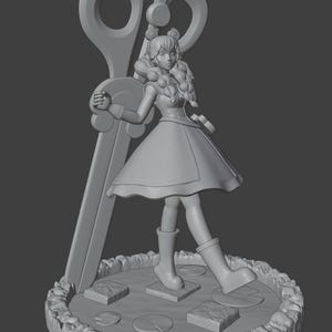 May include: A monochromatic gray 3D-printed figurine of a character with braided hair wearing a dress and boots, standing on a circular base with lily pads and stepping stones, positioned in front of a large pair of upright scissors.