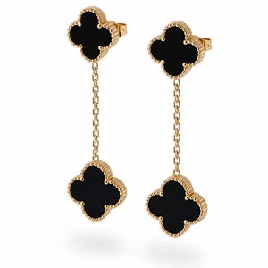 May include: A pair of gold drop earrings featuring two black clover-shaped motifs connected by a delicate gold chain. Each clover has a beaded gold border, and the top motif serves as the stud post with a secure backing for attachment.