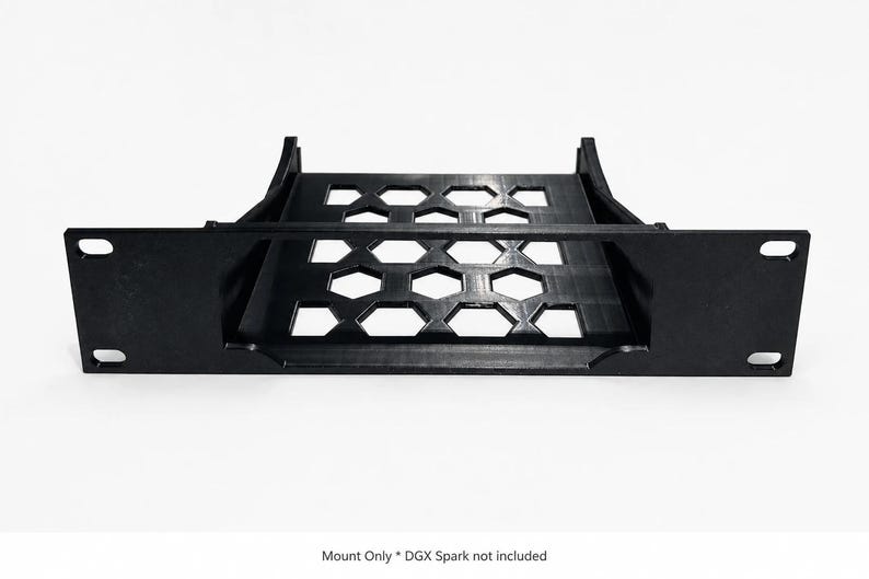 May include: A black rack mount shelf featuring a flat base with a hexagonal cutout pattern and two side support brackets. The front panel includes four mounting holes. The text at the bottom reads: Mount Only * DGX Spark not included.