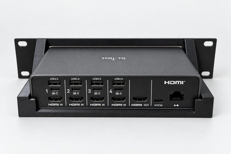 May include: A black GL.iNet HDMI KVM switch mounted in a rack bracket. The front panel features four USB 2.0 ports, four HDMI IN ports labelled 1 through 4, one HDMI OUT port, a 5V3A power input, and an Ethernet port with double arrow icons.
