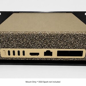 May include: A black metal rack mount holding a gold-colored electronic device with a textured front panel. The device features multiple ports including USB-C, HDMI, and Ethernet. Text at the bottom reads: Mount Only * DGX Spark not included.