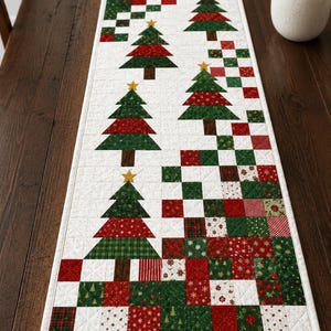 May include: A rectangular quilted table runner featuring a patchwork design of red, green, and white squares with various holiday patterns. Four appliqued Christmas trees with brown trunks and yellow star toppers are arranged along the center.