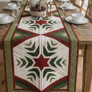 May include: A quilted table runner featuring a geometric star pattern in shades of deep red, forest green, and cream. The runner has a central star motif with radiating chevron lines and a solid green border with linear quilting stitches.