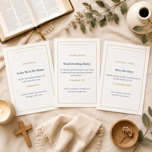May include: Three white rectangular cards with gold borders and dark blue text. The cards are labeled Entryway, Living Room, and Kitchen/Table, each featuring Bible verses from Joshua 24:15, Colossians 3:16, and 1 Corinthians 10:31 respectively.