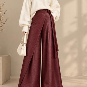 Pantalones palazzo cruzados de piel sintética, pantalones de pierna ancha de talle alto, cinturón ajustable.