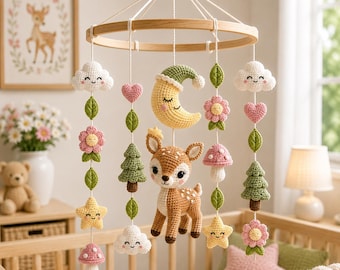 May include: A nursery mobile featuring crocheted elements suspended from a circular wooden frame. The hanging items include a central fawn, a yellow crescent moon, white clouds, pink flowers, green pine trees, pink mushrooms, and yellow stars.