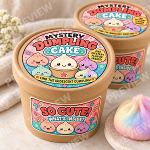 Peut inclure: Deux contenants ronds en carton étiquetés Mystery Dumpling Cake avec des illustrations de boulettes de pâte en dessin animé. Les étiquettes portent le texte So Cute! What's Inside? et Find the Iridescent Dumpling! Une boulette irisée est posée sur une assiette.