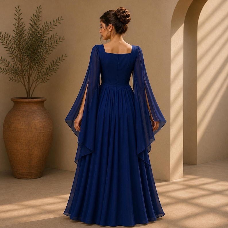 May include: A floor-length navy blue gown featuring a square neckline and long, flowing split sleeves. The dress is crafted from a sheer, layered fabric that creates a voluminous skirt, with a fitted bodice that highlights a clean, structured silhouette.