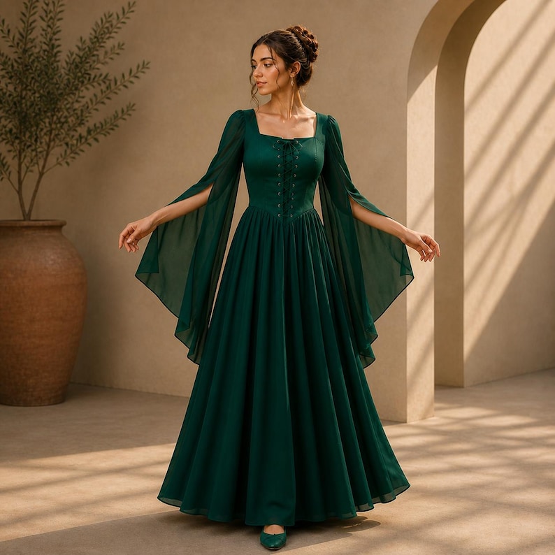 May include: A floor-length dark green dress featuring a square neckline, a lace-up bodice detail, and long, flowing split sleeves. The garment has a fitted waist that transitions into a full, pleated skirt made of a lightweight, sheer fabric.