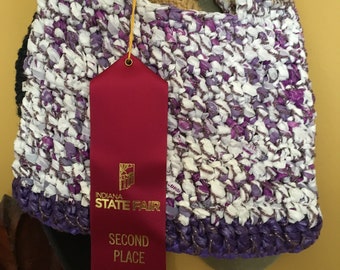 Purple and white plastic purse crocheted with plastic bags and yarn