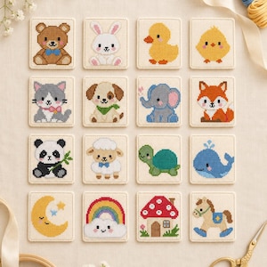 May include: A collection of sixteen square cross-stitch patches featuring various embroidered designs including a bear, rabbit, duck, chick, cat, dog, elephant, fox, panda, sheep, turtle, whale, moon, rainbow, mushroom house, and rocking horse.