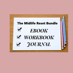 May include: A white rectangular sheet of paper with the text The Midlife Reset Bundle at the top, followed by a checklist with the items EBOOK, WORKBOOK, and JOURNAL. Three colored pencils in pink, purple, and blue are placed on the right side.