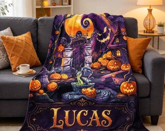 May include: A plush throw blanket featuring a vibrant Halloween scene with a large yellow moon, a spooky iron gate, a haunted house, and numerous jack-o'-lanterns. The bottom section displays the name LUCAS in large, decorative gold lettering.