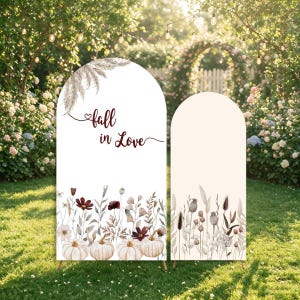 May include: Two arched display panels featuring a white background with watercolor illustrations of dried grasses, wildflowers, and white pumpkins. The larger panel displays the text "fall in Love" in a dark red script font with a small heart.