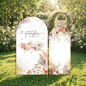 May include: Two arched display panels featuring white backgrounds with watercolor illustrations of pumpkins, pampas grass, and floral arrangements. The larger panel includes the text A sweet little pumpkin is on the way in black script.