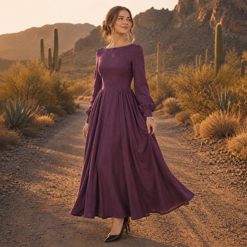Puede incluir: Un vestido largo hasta el suelo de color morado ciruela intenso con mangas largas. La prenda presenta un corpi&ntilde;o ajustado, un escote redondeado y una falda amplia y plisada que cae hacia el dobladillo. Las mangas tienen pu&ntilde;os fruncidos.