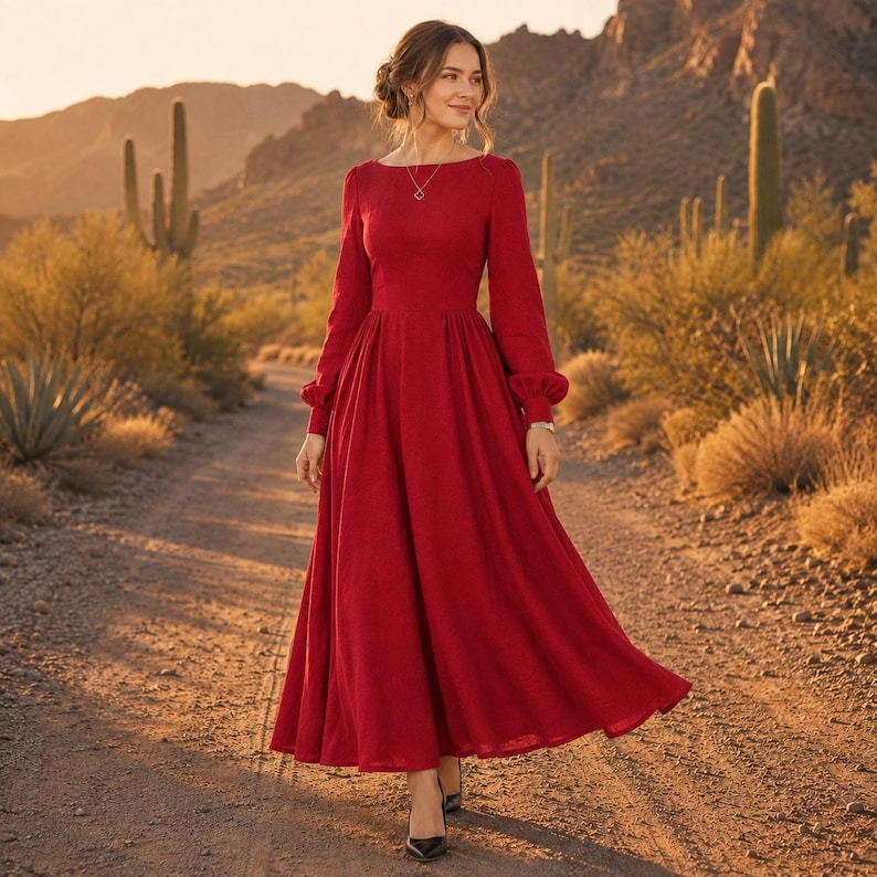 Puede incluir: Un vestido largo hasta los tobillos de color rojo intenso con mangas largas. El vestido presenta un corpi&ntilde;o ajustado, una cintura definida y una falda amplia y fluida que llega hasta los tobillos. Las mangas son largas con pu&ntilde;os fruncidos y el escote es redondo.