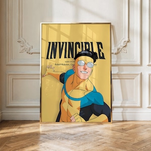 May include: A framed poster featuring the character Invincible with black hair and round glasses, wearing a yellow and blue suit. The background is yellow with the bold black text INVINCIBLE and smaller text reading Based on the Robert Kirkman comic.